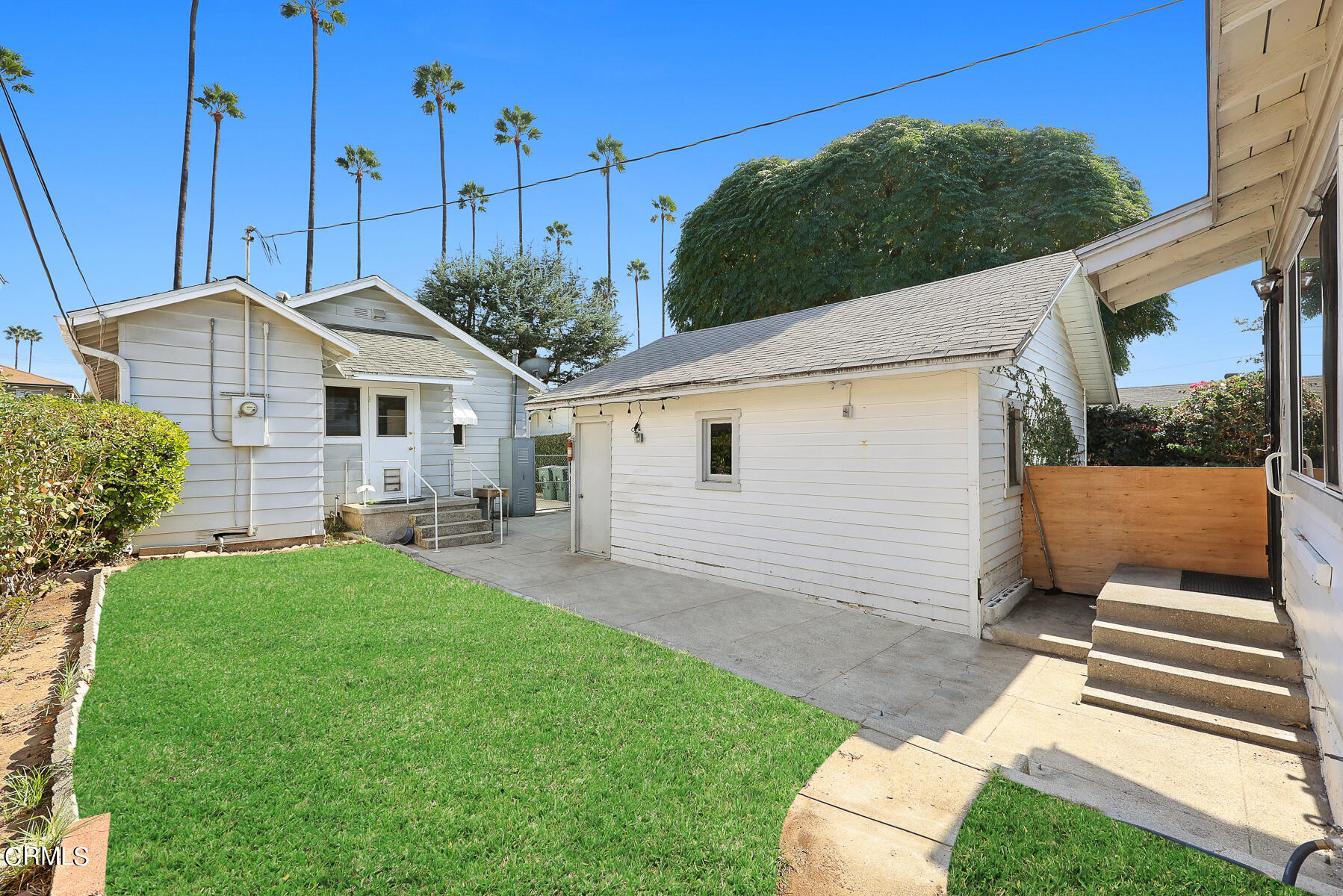 1159 Western Avenue Glendale, CA 91201 - Photo 34 of 52 a view of a white house next to a yard with big trees