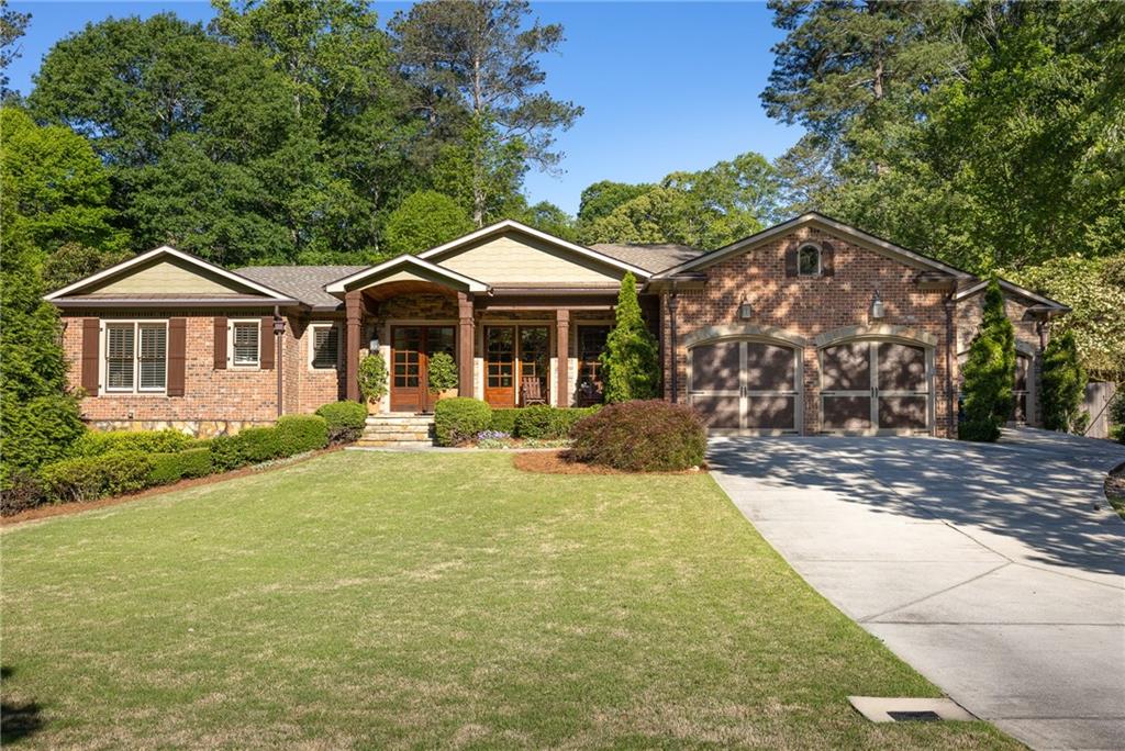 a front view of a house with yard porch and green space