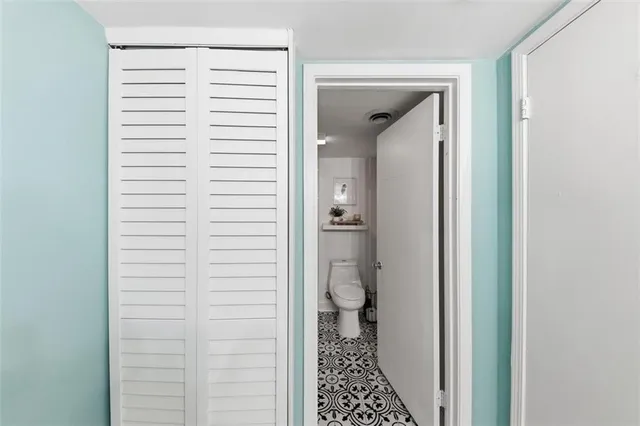 a bathroom with a toilet and a shower