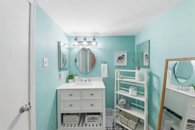 a bathroom with a double vanity sink and a mirror