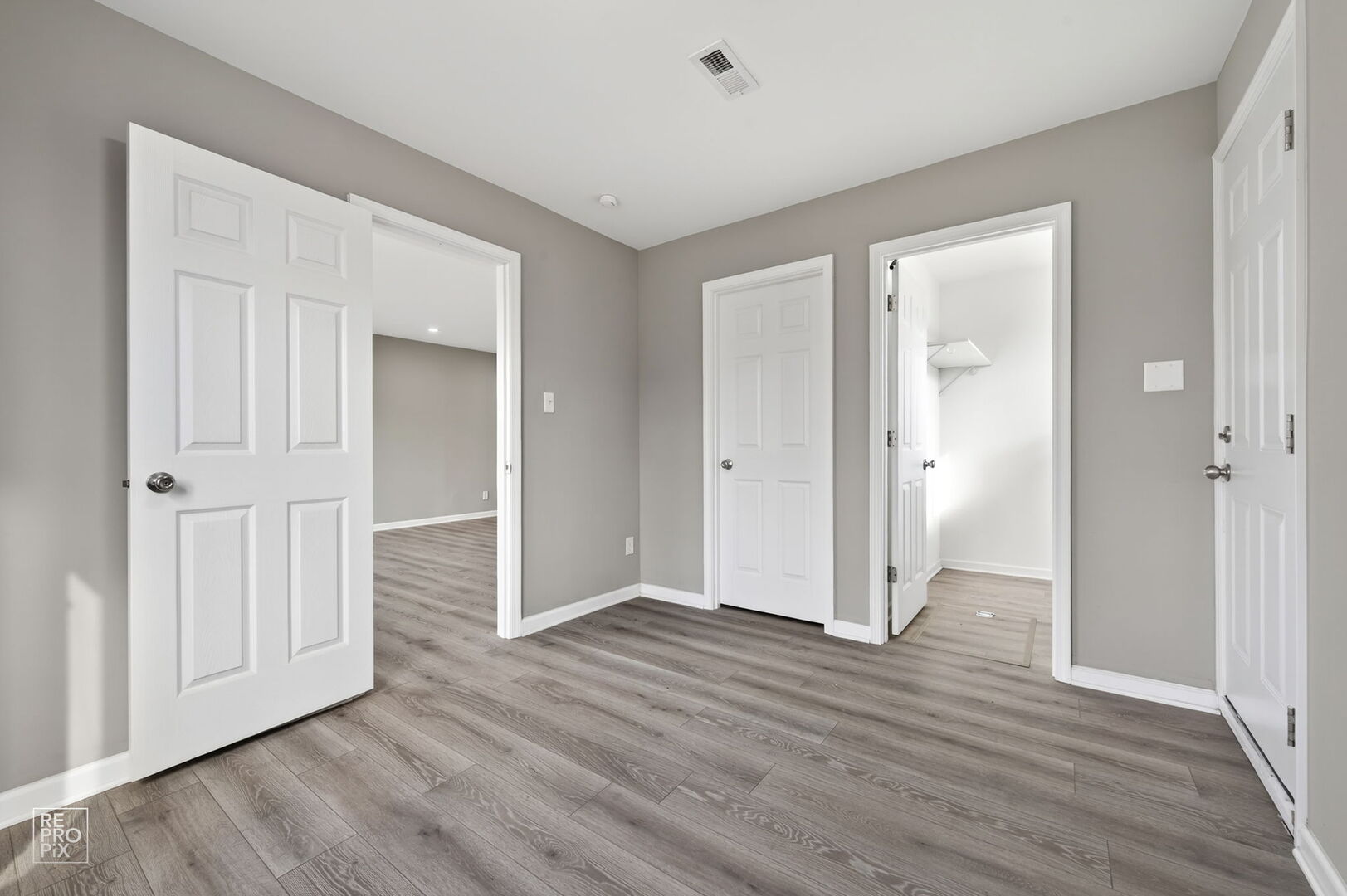 4680 West 83rd Street Chicago, IL 60652 - Photo 10 of 22 an empty room with wooden floor & windows and bathroom