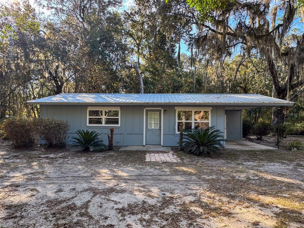 468 Southeast 18th Street Melrose, FL 32666 - Photo 1 of 1 a front view of house with yard and trees around