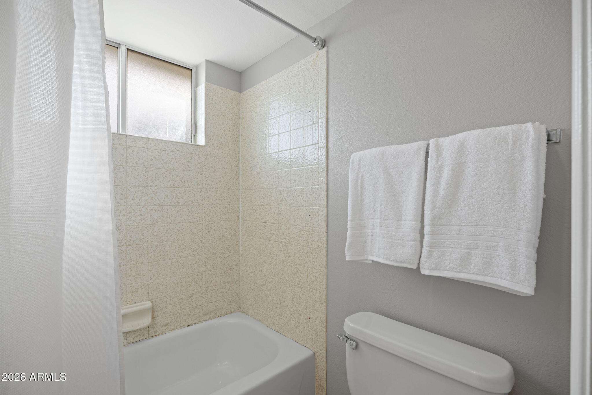 5917 East Hearn Road Scottsdale, AZ 85254 - Photo 20 of 28 a bathroom with a toilet and a bathtub