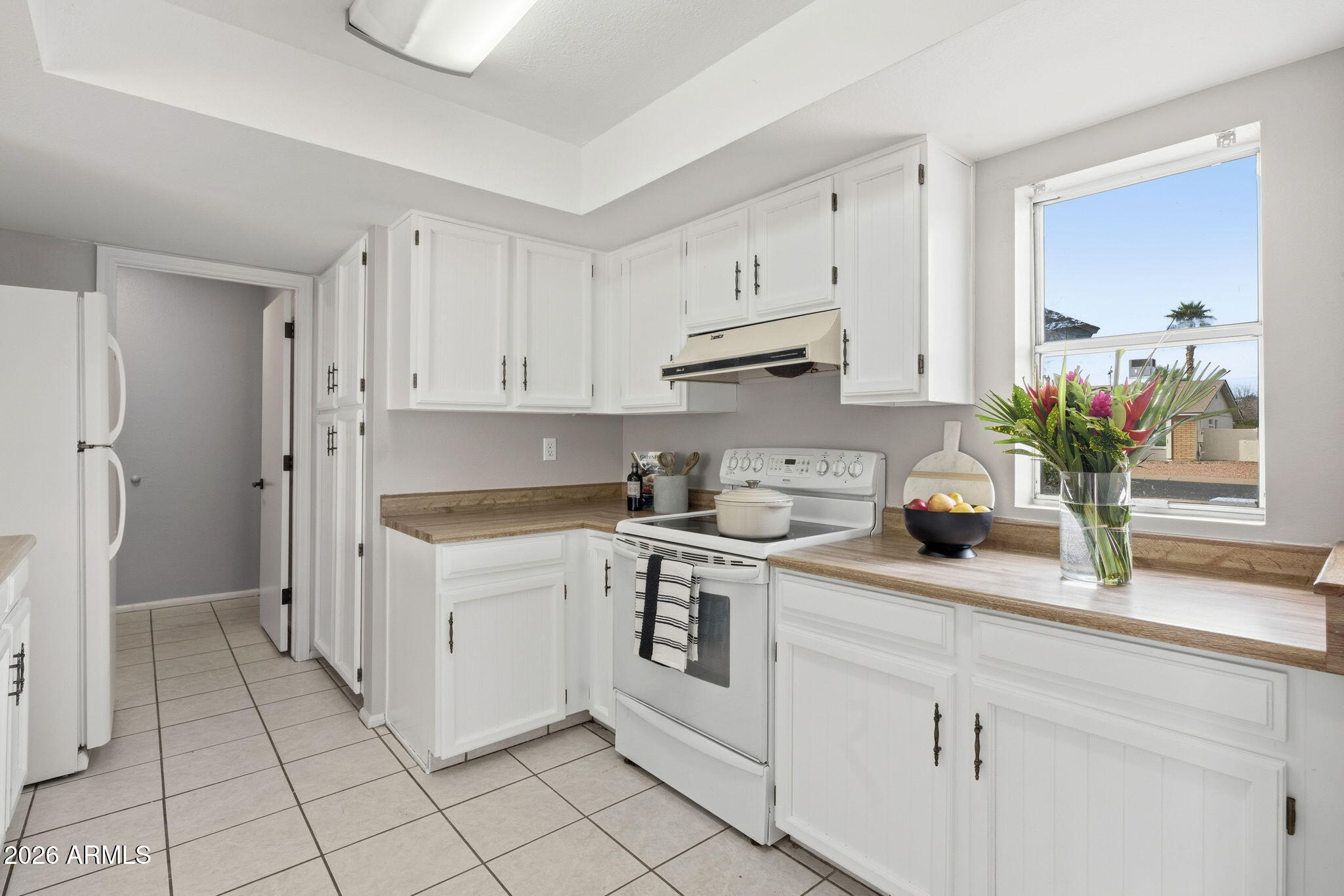 5917 East Hearn Road Scottsdale, AZ 85254 - Photo 25 of 28 a kitchen with white cabinets and white appliances