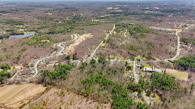 an aerial view of residential house with beach and green space
