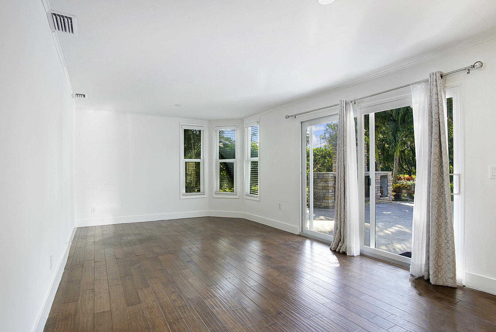 924 Pompano Drive Jupiter, FL 33458 - Photo 18 of 36 wooden floor in an empty room with a window