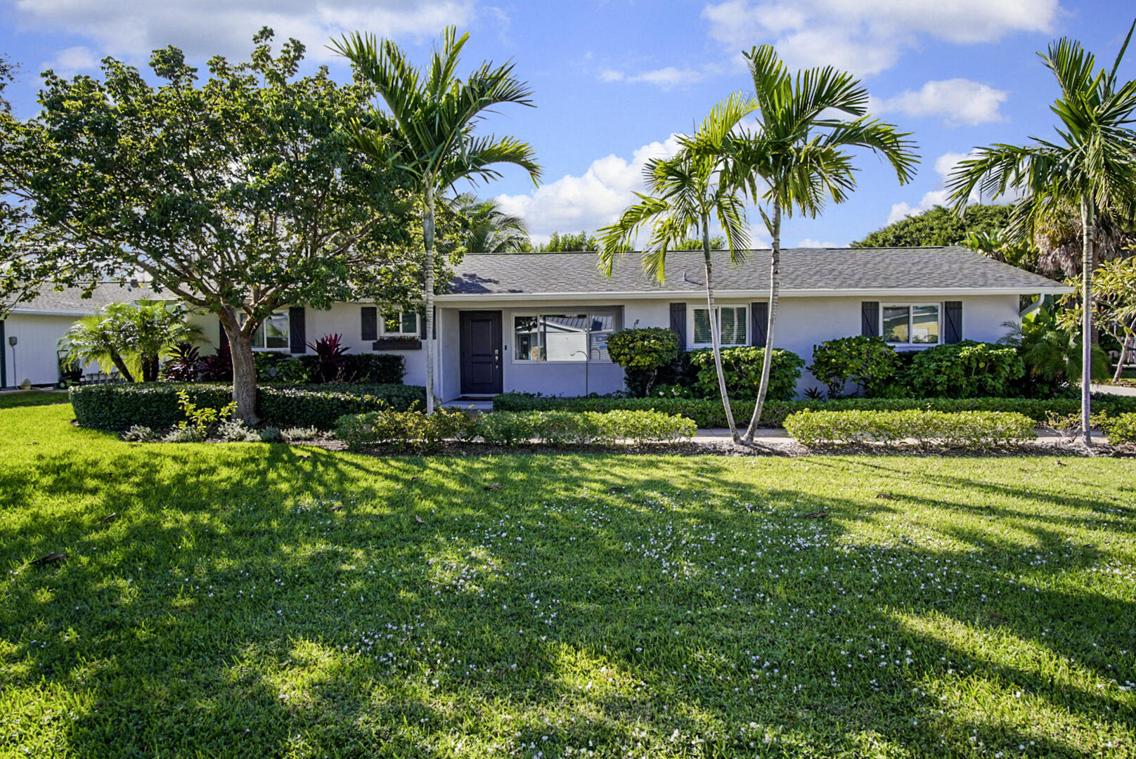 924 Pompano Drive Jupiter, FL 33458 - Photo 2 of 36 a front view of house with yard and green space
