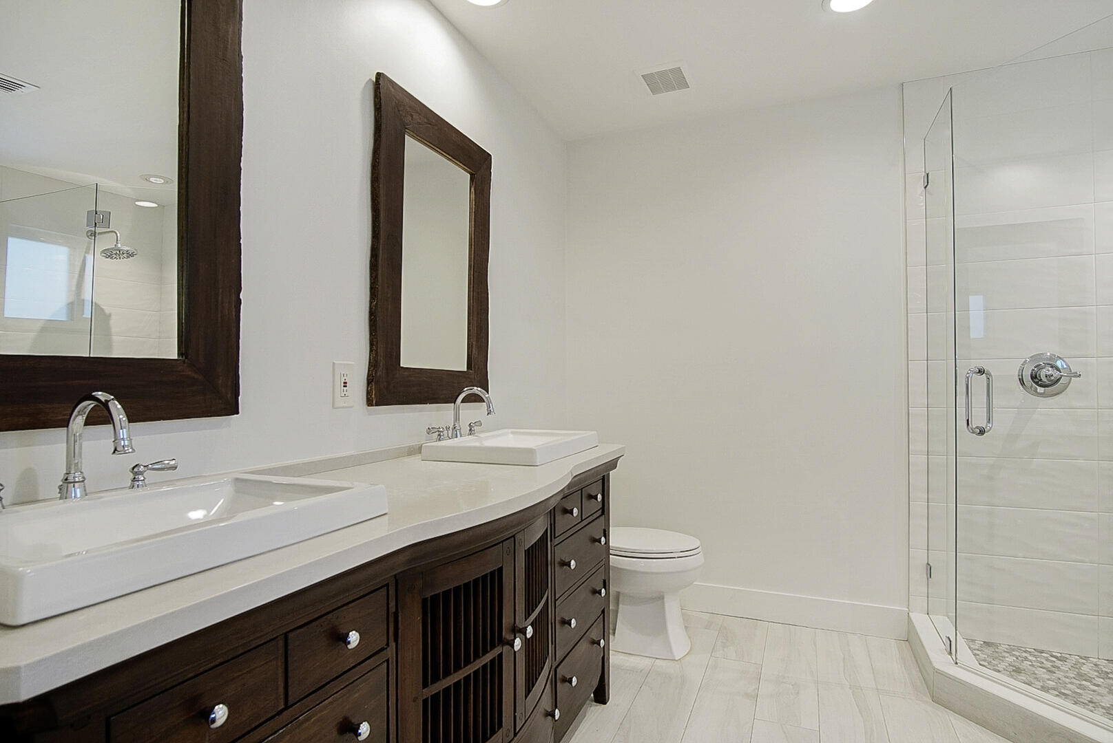 924 Pompano Drive Jupiter, FL 33458 - Photo 22 of 36 a bathroom with a double vanity sink toilet and shower