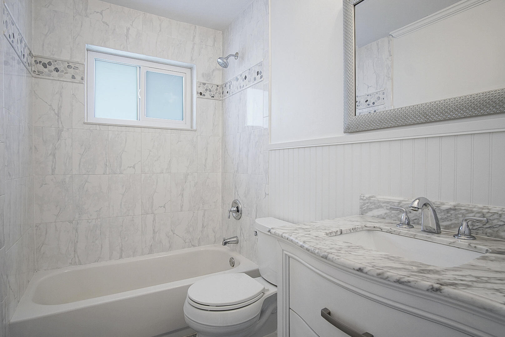 924 Pompano Drive Jupiter, FL 33458 - Photo 27 of 36 a bathroom with a granite countertop sink a toilet and shower