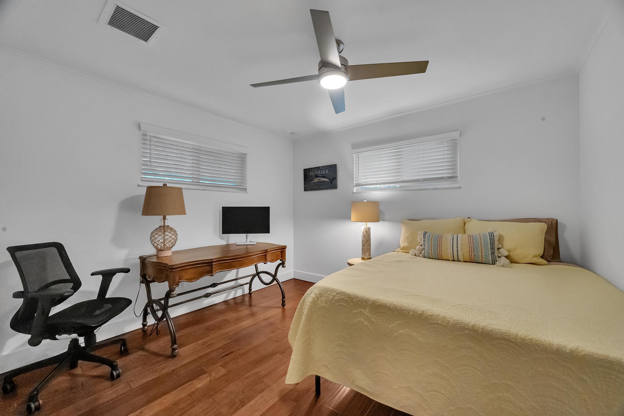 924 Pompano Drive Jupiter, FL 33458 - Photo 29 of 36 a bedroom with a bed a desk and chair