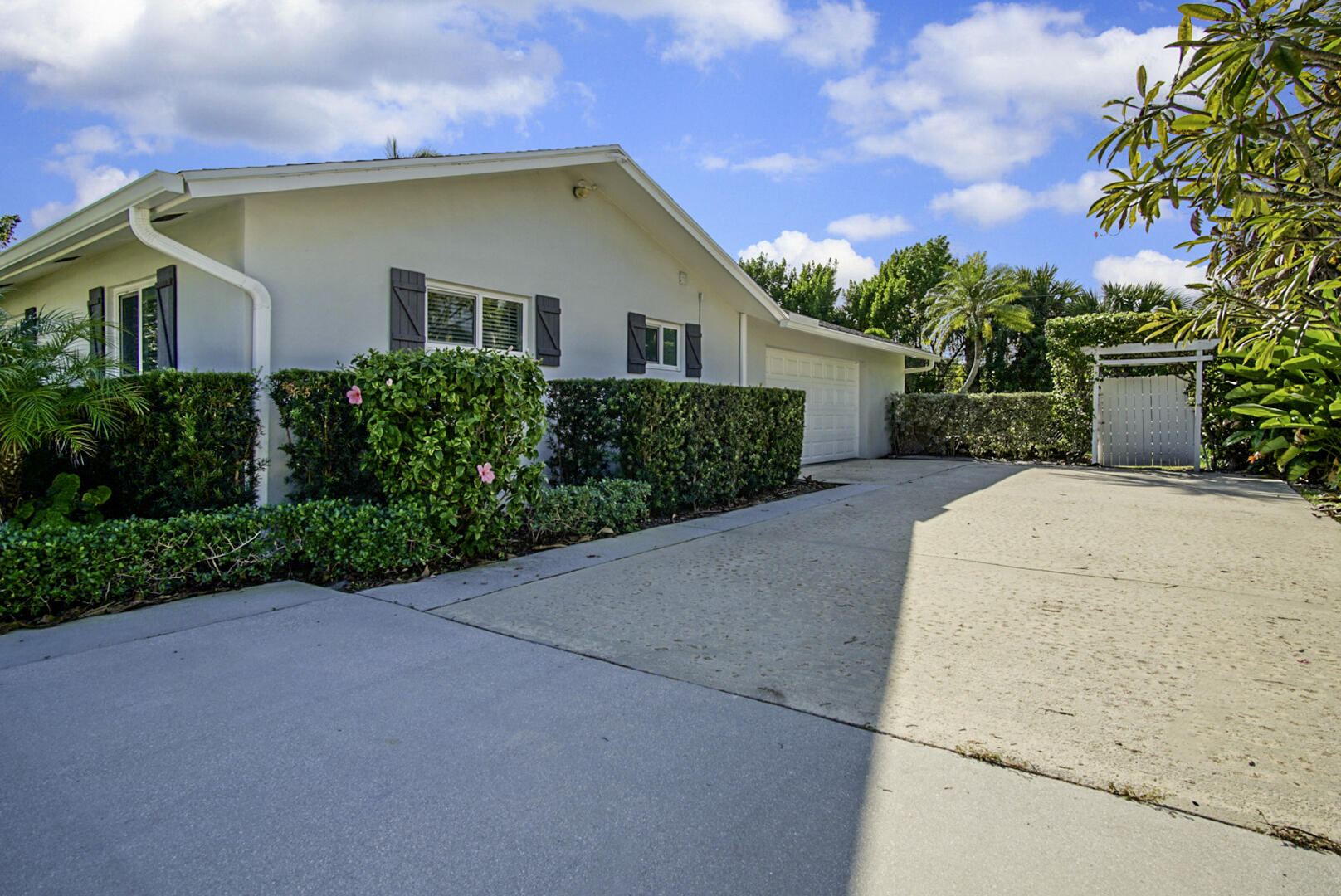 924 Pompano Drive Jupiter, FL 33458 - Photo 33 of 36 a view of a house with a yard and garage