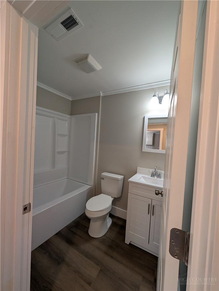 68 Estep Street Sparta, NC 28675 - Photo 12 of 21 a bathroom with a sink toilet a mirror and shower