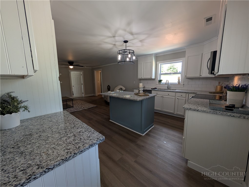 68 Estep Street Sparta, NC 28675 - Photo 3 of 21 a kitchen with granite countertop sink stainless steel appliances and cabinets