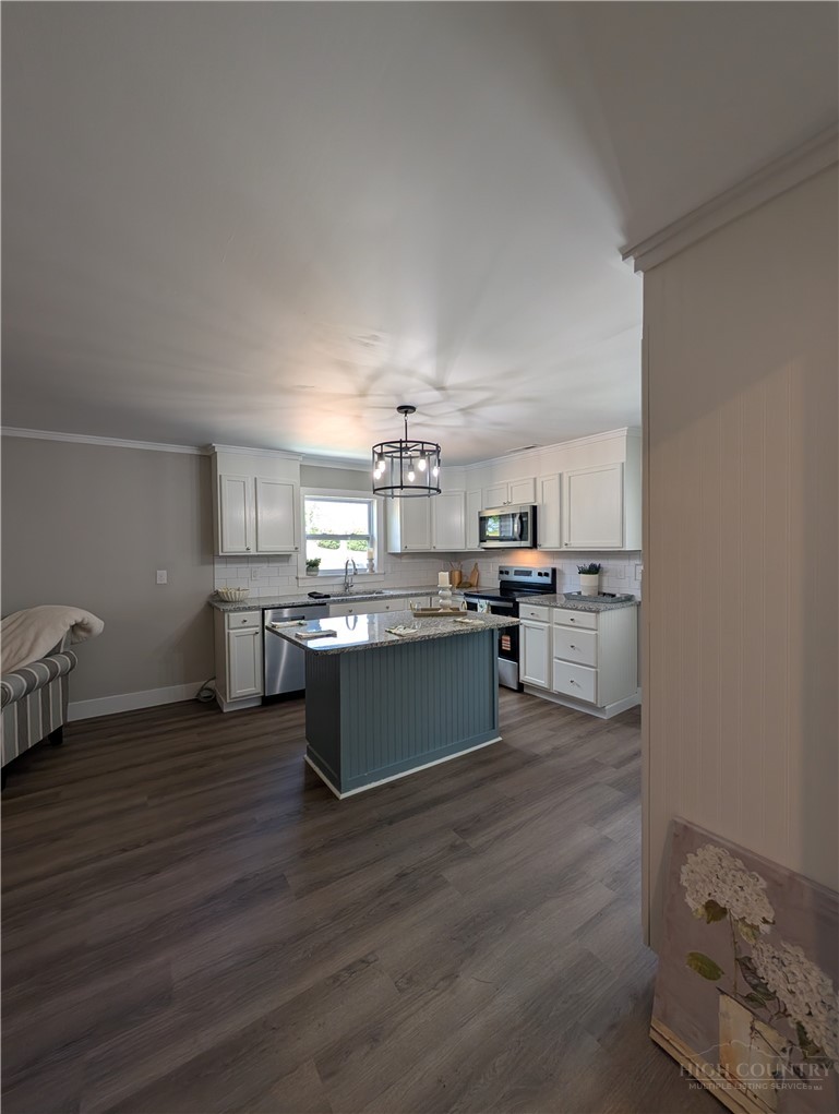 68 Estep Street Sparta, NC 28675 - Photo 5 of 21 a view of a kitchen with wooden floor