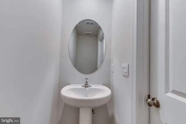 a bathroom with a sink and mirror