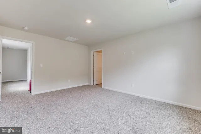a bathroom with a granite countertop sink a toilet and shower