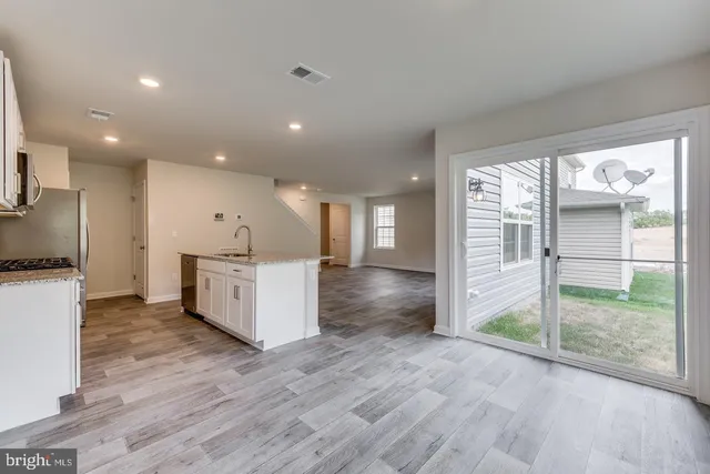 a view of a kitchen with a sink and a large window