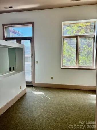 a view of a big room with closet and windows