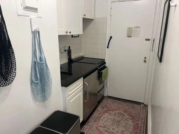 a living room with furniture or couch and a bookshelf