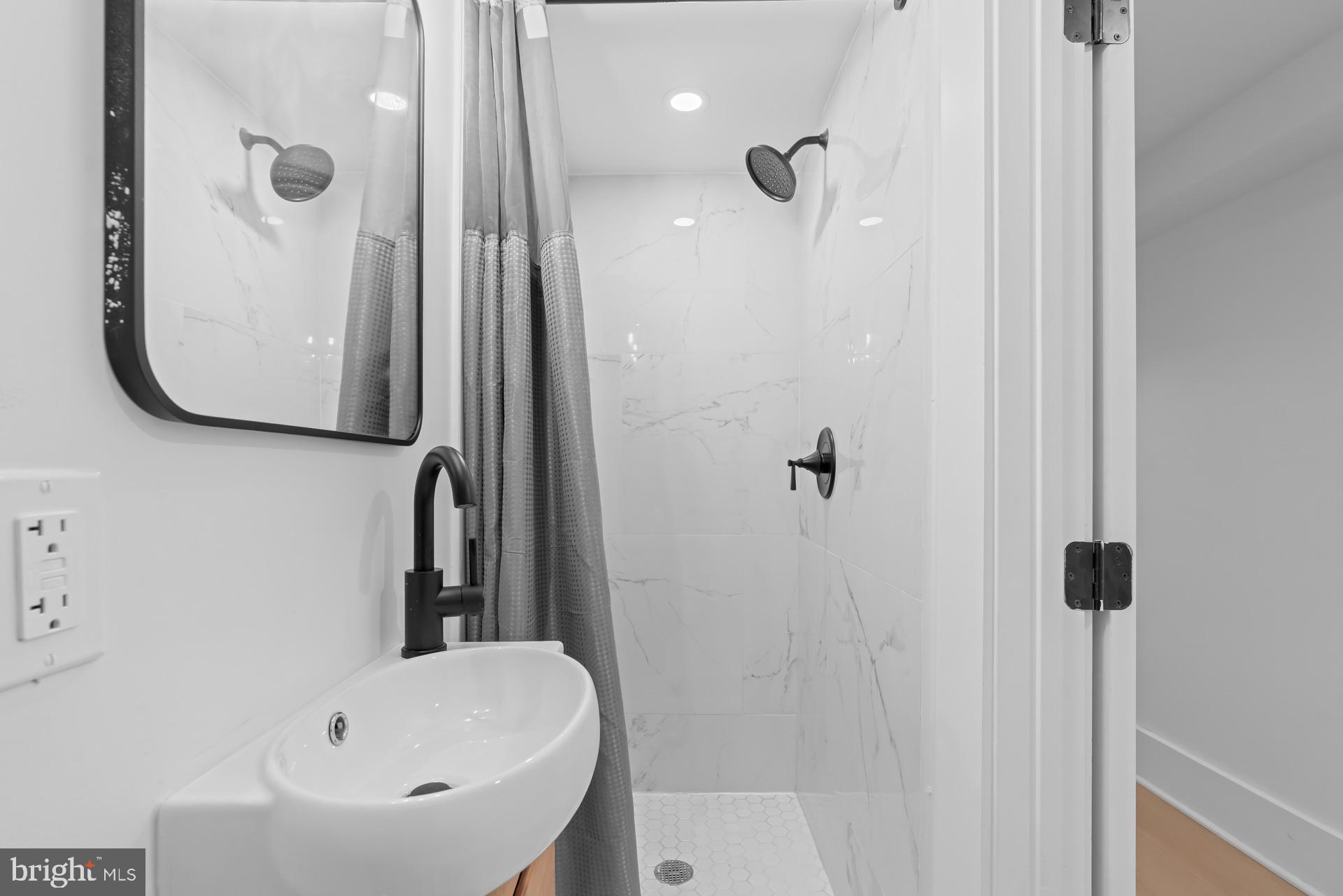 939 Shepherd Street Northwest Washington, DC 20011 - Photo 23 of 45 a bathroom with a sink a toilet and shower