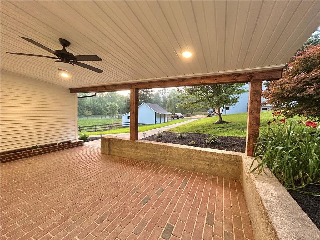 72 Allegheny Road Mount Bethel, PA 18343 - Photo 3 of 72 An inviting brick patio provides an ideal setting for outdoor enjoyment, overlooking a peaceful landscape.