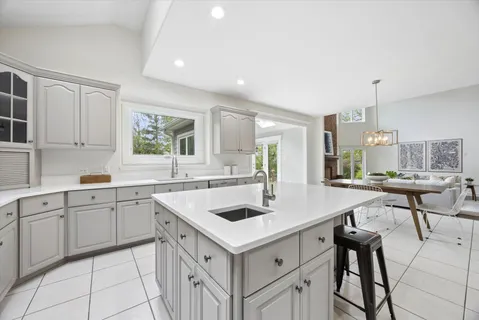 a kitchen with a stove a sink and cabinets