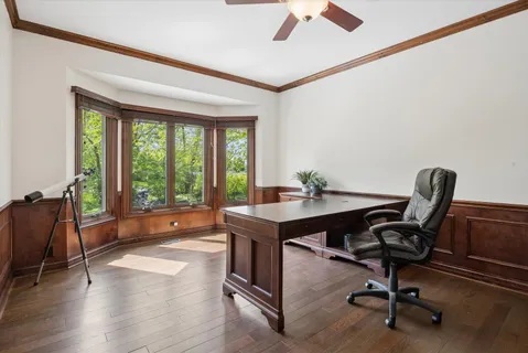 a view of a workspace with furniture and a window