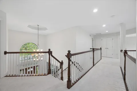 a view of staircase with lots of frames and a window