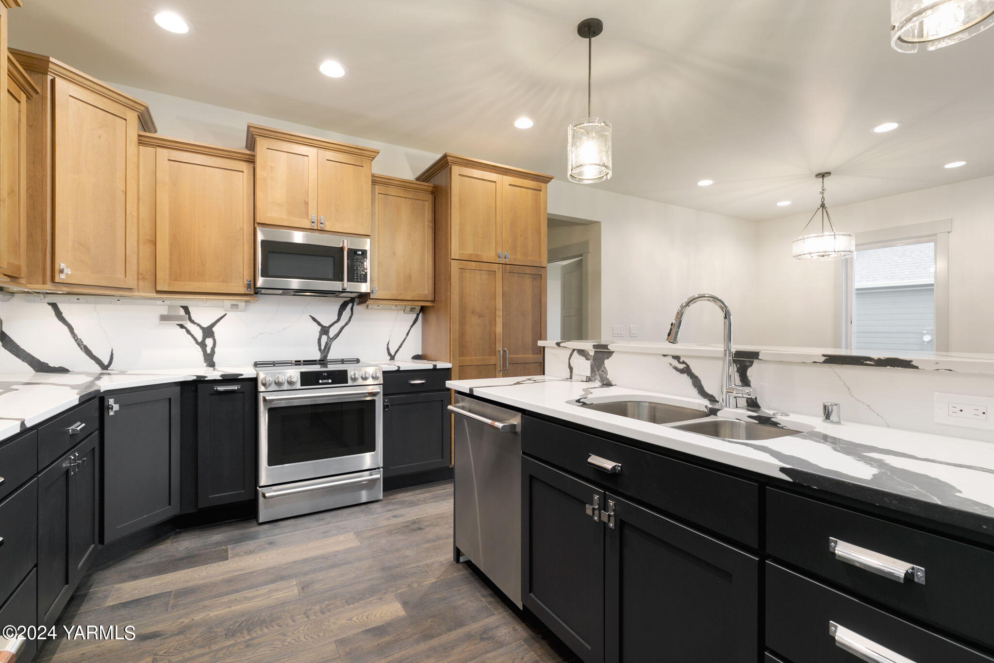 7202 Vista Ridge Avenue Yakima, WA 98903 - Photo 12 of 24 a kitchen with stainless steel appliances granite countertop a sink a stove and a refrigerator