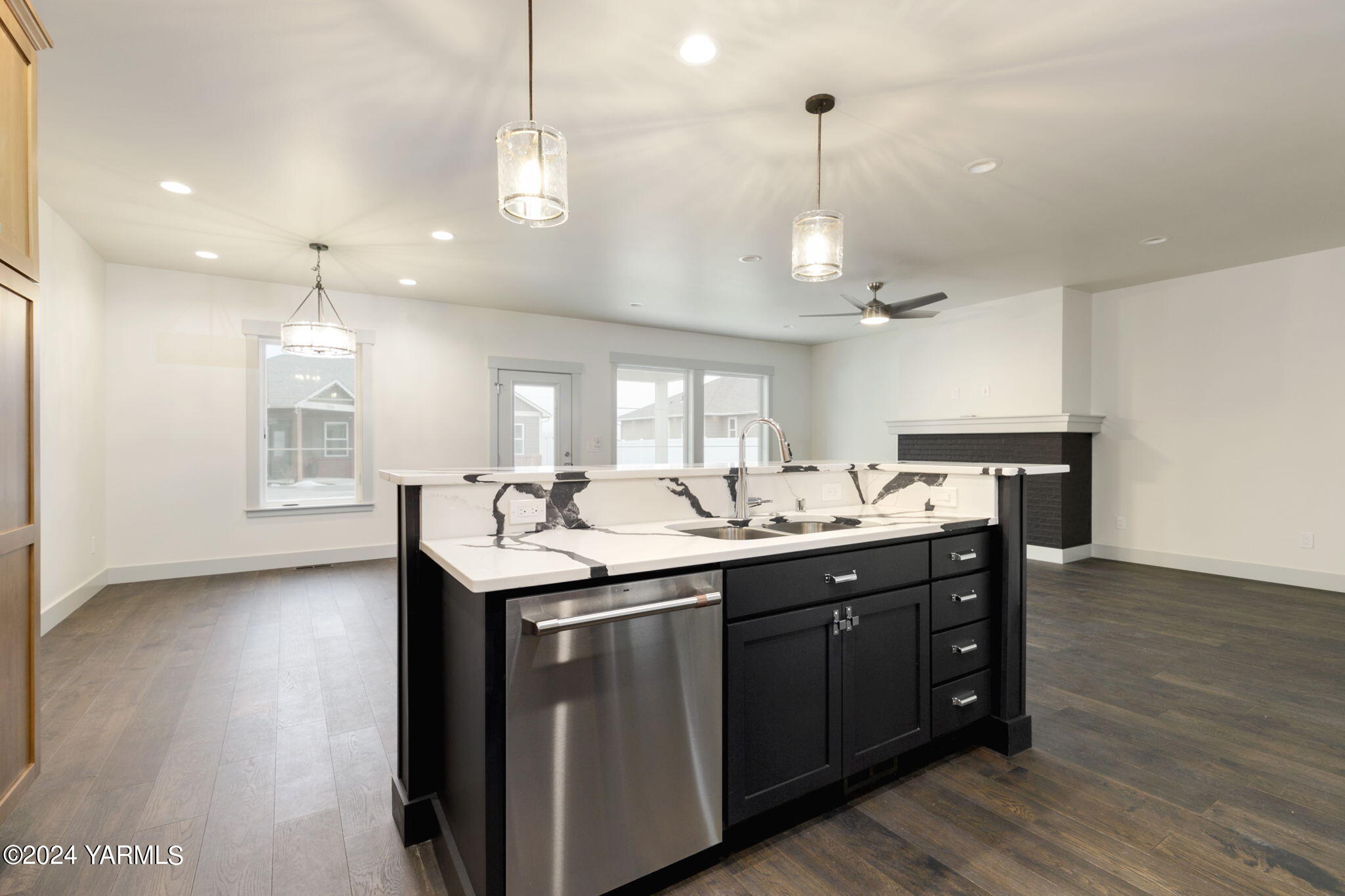 7202 Vista Ridge Avenue Yakima, WA 98903 - Photo 14 of 24 a kitchen with kitchen island a sink and a stove top oven