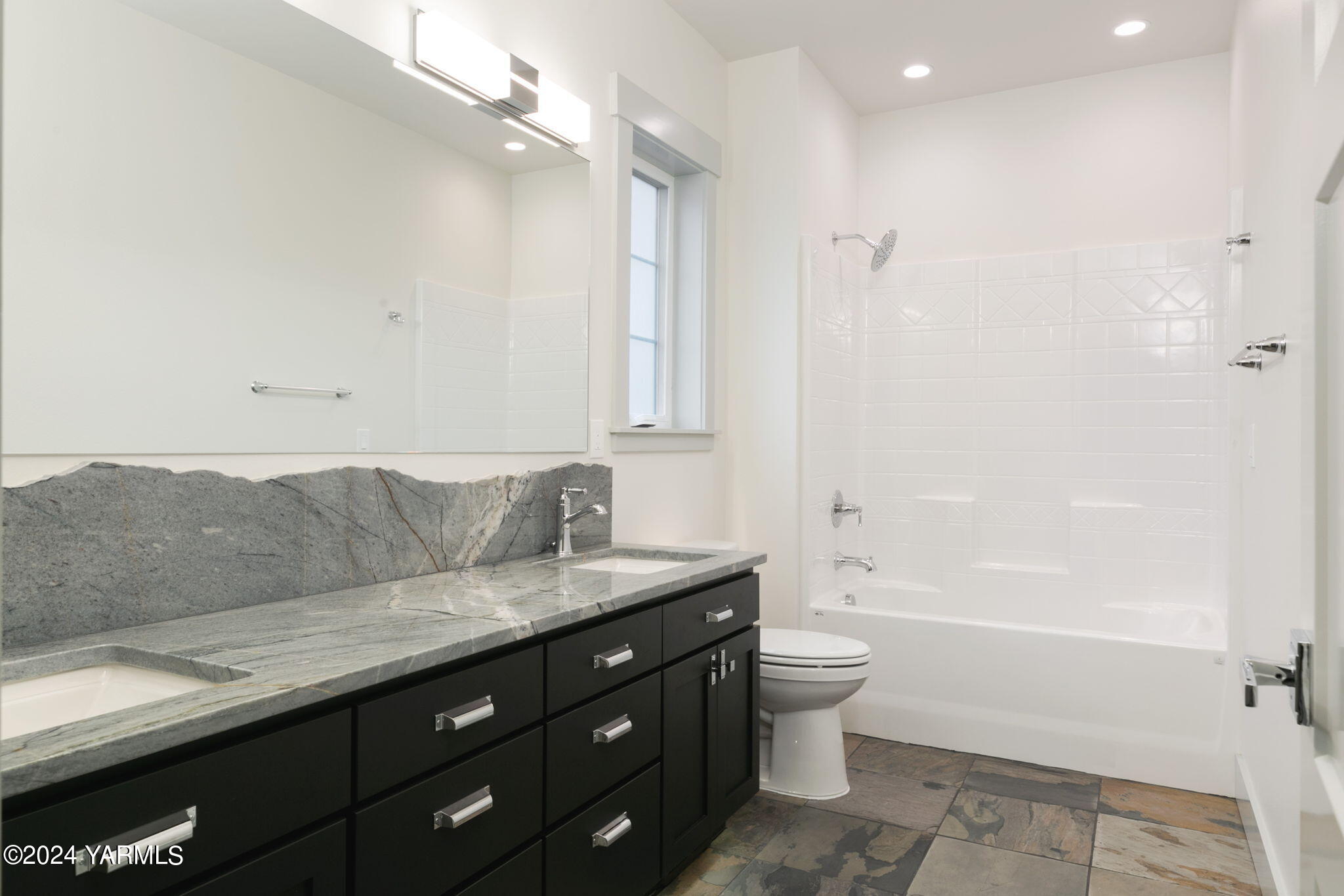 7202 Vista Ridge Avenue Yakima, WA 98903 - Photo 22 of 24 a bathroom with a granite countertop sink a toilet and shower