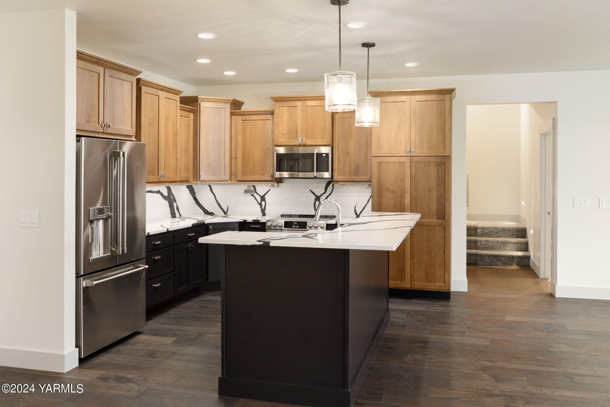 7202 Vista Ridge Avenue Yakima, WA 98903 - Photo 10 of 24 a kitchen with kitchen island stainless steel appliances a sink stove and refrigerator
