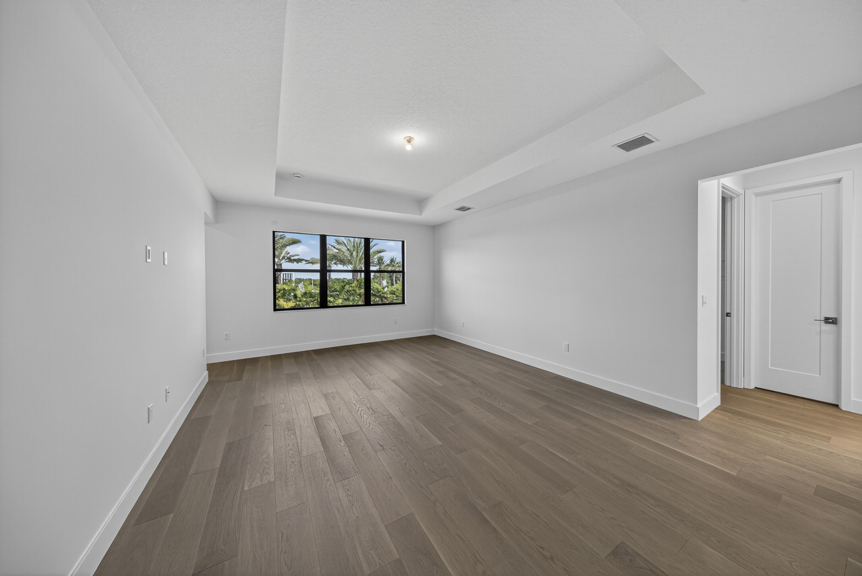 9361 Sunflower Mdw Road Boca Raton, FL 33434 - Photo 16 of 39 an empty room with wooden floor and windows