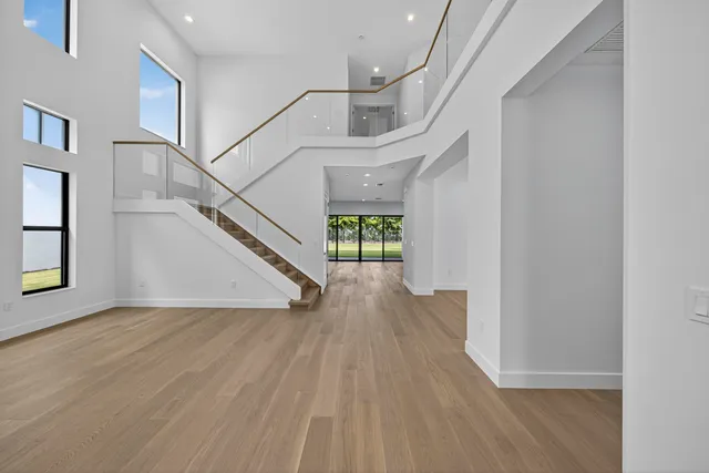 a bathroom with a granite countertop toilet a sink and mirror