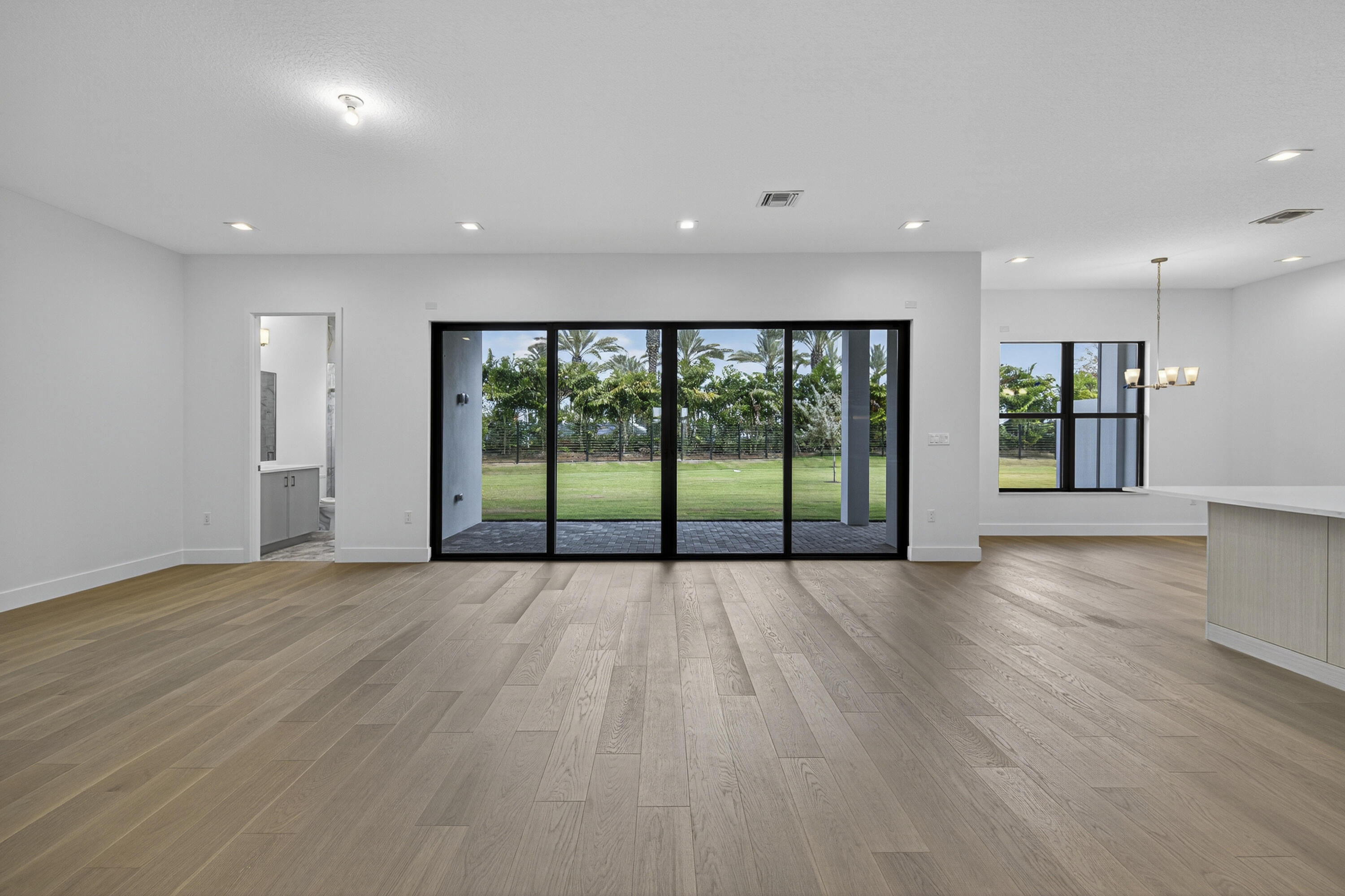 9361 Sunflower Mdw Road Boca Raton, FL 33434 - Photo 7 of 39 a view of an empty room with wooden floor and a window