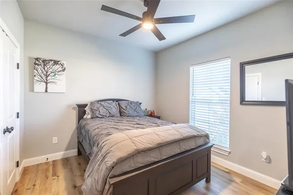 a bedroom with a bed and a painting on the wall