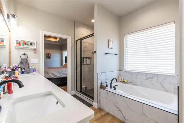 a bathroom with a tub sink and mirror