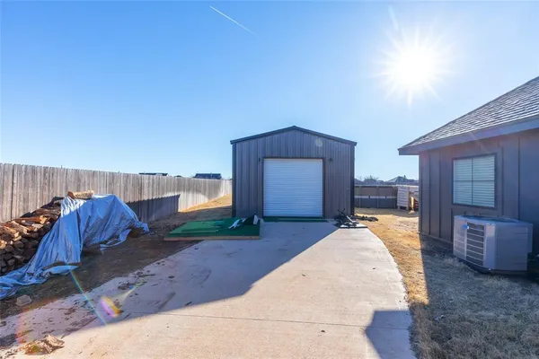 a front view of house with yard and trees in the background