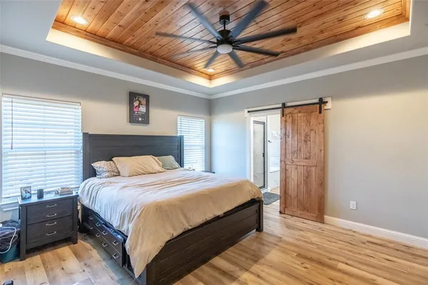 a bedroom with a bed and a chandelier