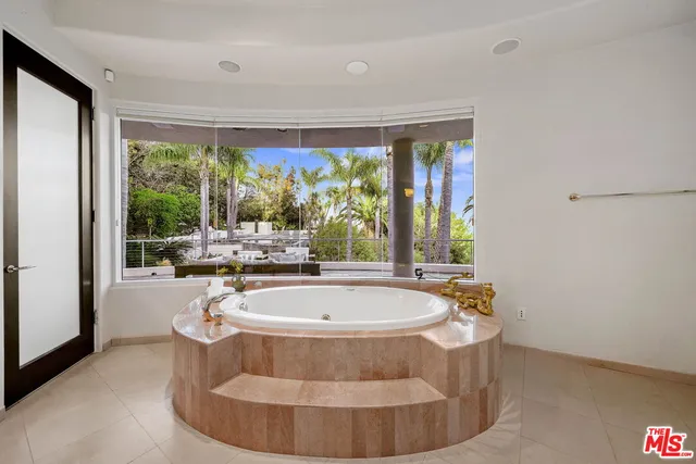 a room with wooden floor and outdoor seating