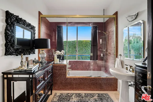 a living room with a flat screen tv and a floor to ceiling window