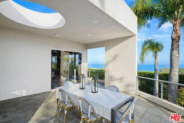 a view of a dining room with furniture and window