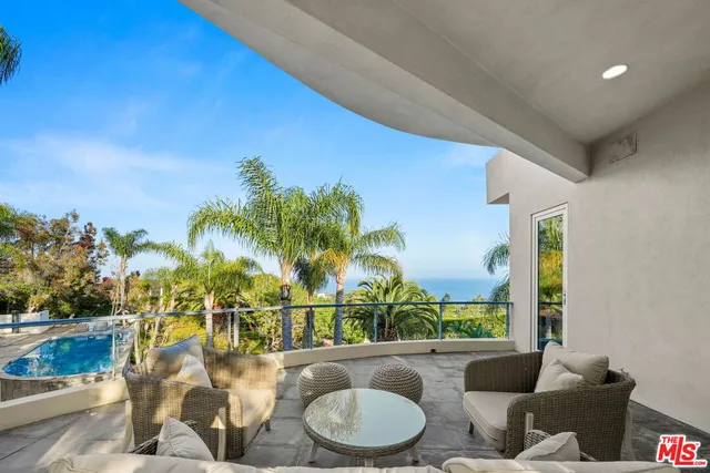 a view of balcony with furniture and garden
