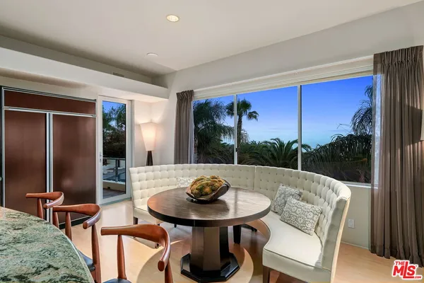 a view of a dining room with furniture window and outside view