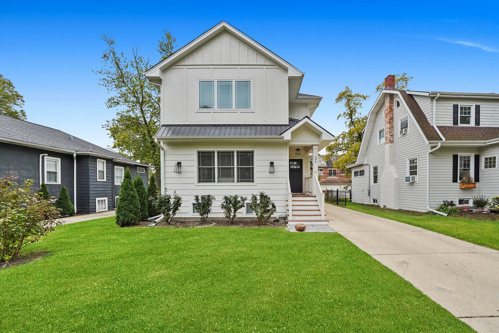 a front view of a house with a yard and porch