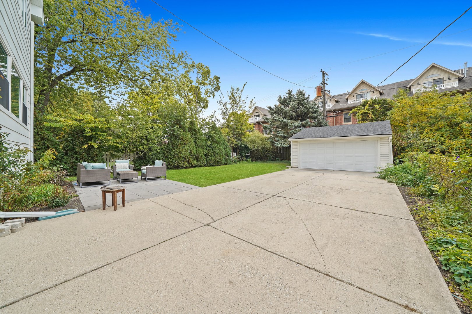 295 Herrick Road Riverside, IL 60546 - Photo 2 of 32 a view of a patio with table and chairs and potted plants