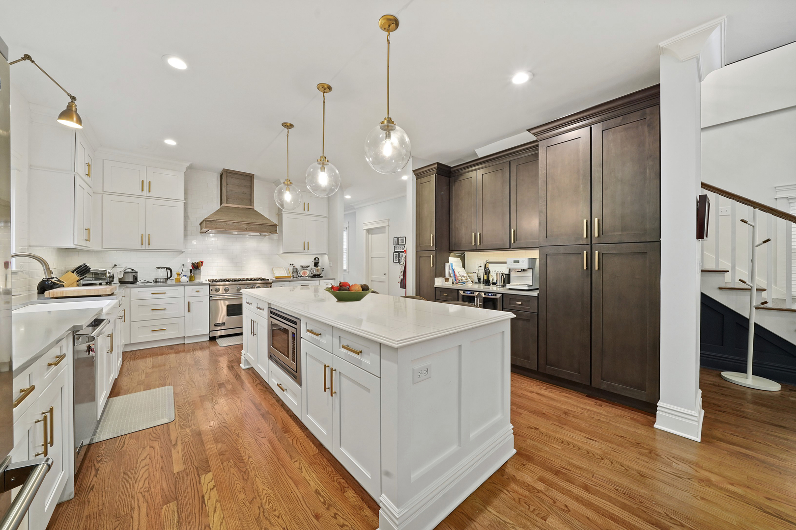 295 Herrick Road Riverside, IL 60546 - Photo 13 of 32 a kitchen with stainless steel appliances kitchen island granite countertop a refrigerator a stove a sink and white cabinets with wooden floor