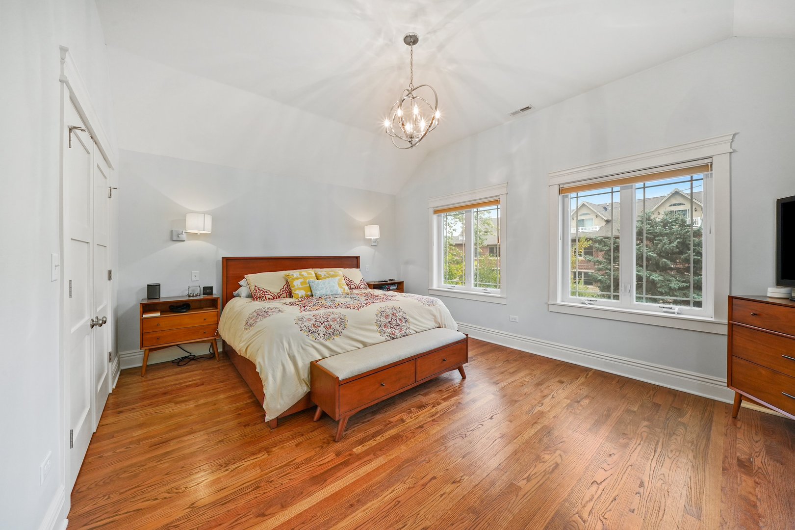 295 Herrick Road Riverside, IL 60546 - Photo 18 of 32 a spacious bedroom with a bed chandelier and windows