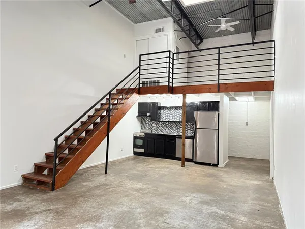 a view of a kitchen with furniture and stairs