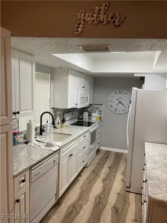 a kitchen with stainless steel appliances granite countertop a sink and cabinets